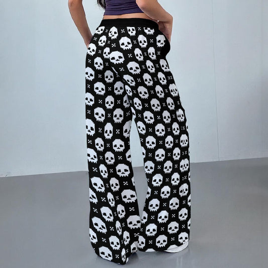 Skull patterned pants worn by a person on a plain background
