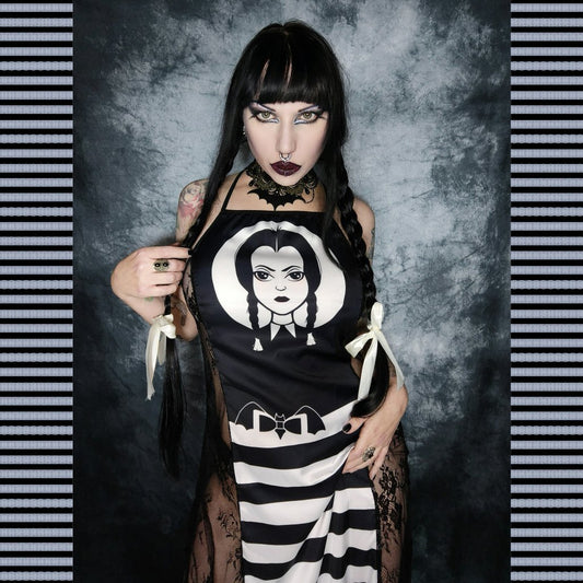 This image features the "Wednesday Cami Cross Back Dress," a stylish and striking garment ideal for those seeking a blend of elegance and modern fashion. The dress is designed with sexy black lace mesh detailing on the sides, enhancing its ethereal and seductive appeal.